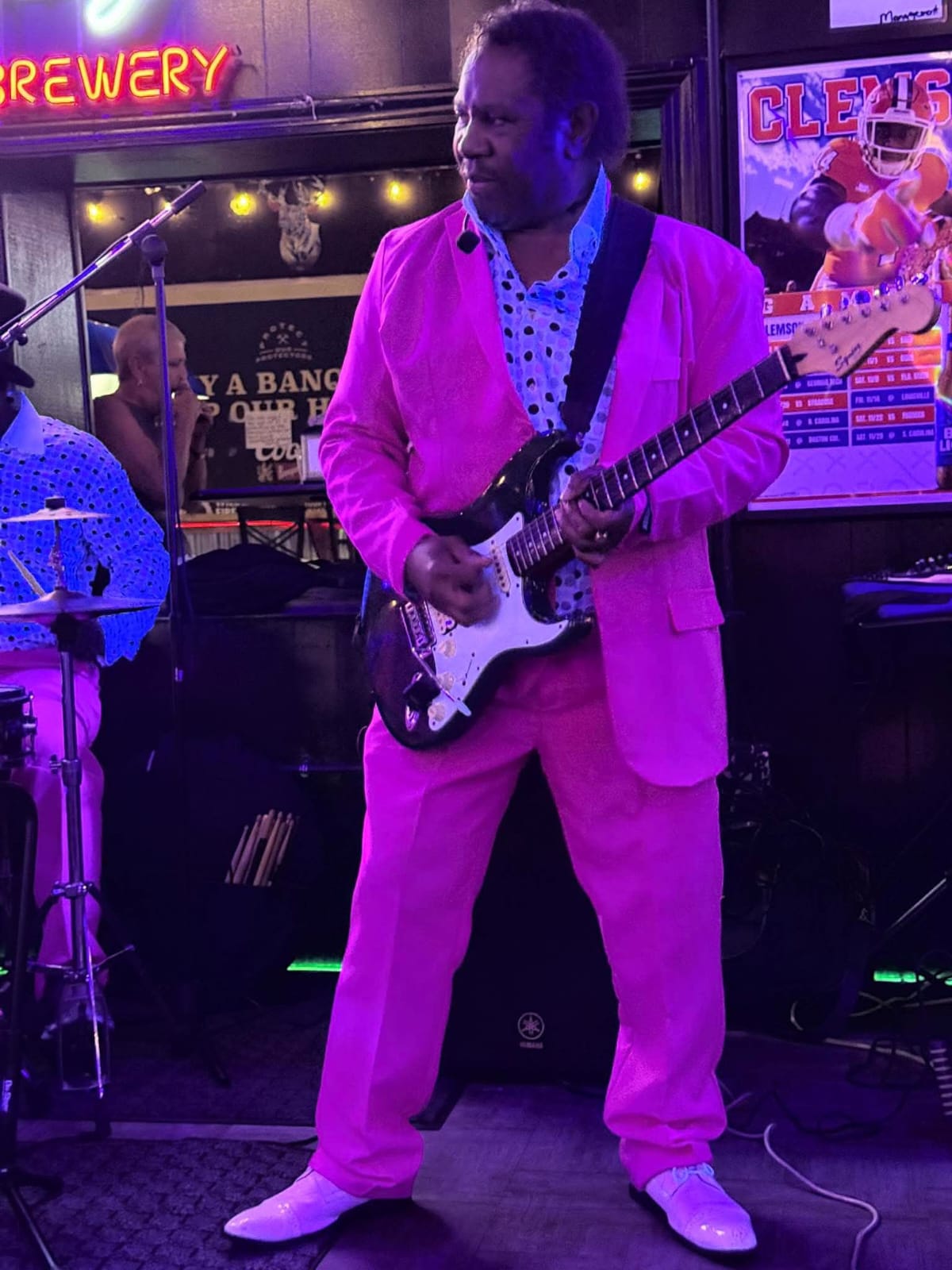 Eugene preparing guitar for performance