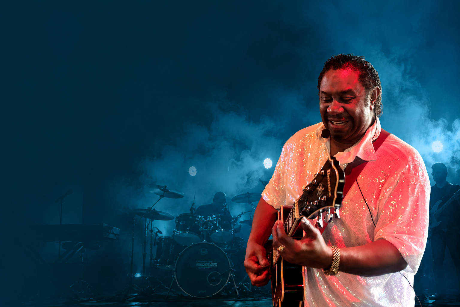 Guitarist performing on a concert stage